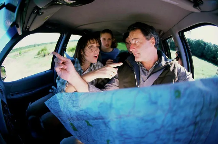 Framed Print : Couple arguing in a car over a map Framed Print : Couple arguing in a car over a map