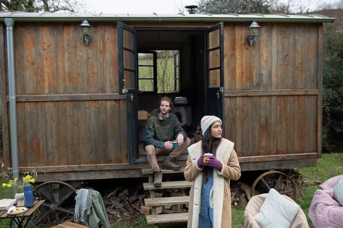 Framed Print : Couple enjoying coffee outside tiny cabin rental