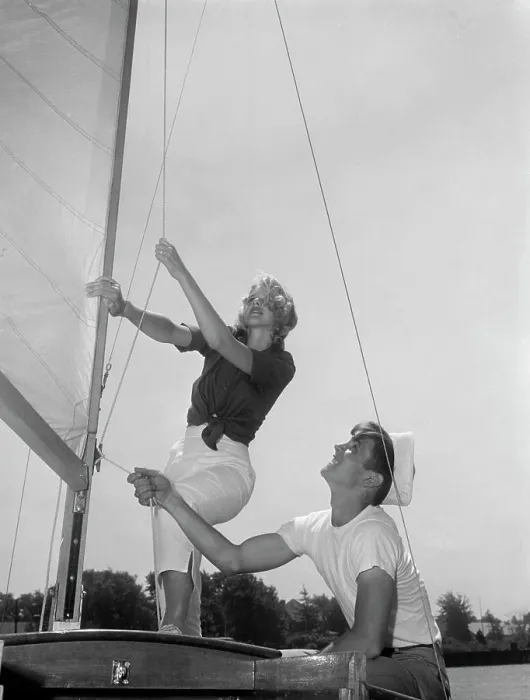 Framed Print : Couple on yacht deck adjusting sail