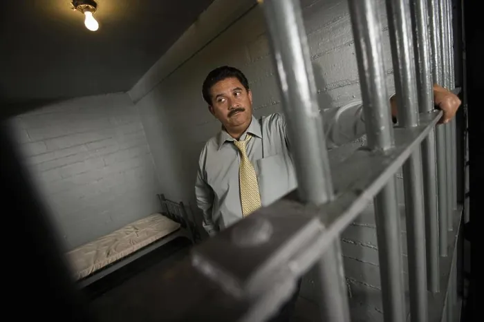 Framed Print : Criminal behind bars in jail Framed Print : Criminal behind bars in jail