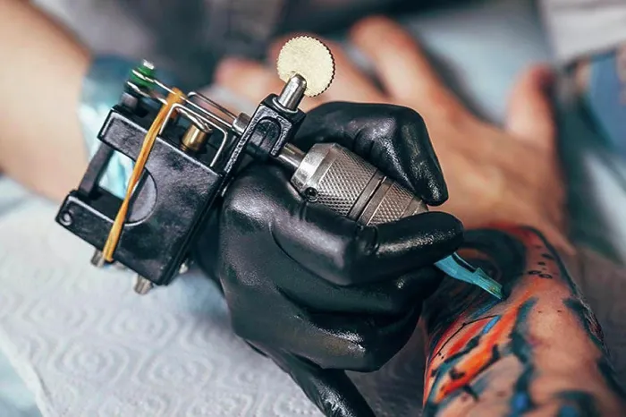 Framed Print : Cropped image of artist tattooing design on human hand Framed Print : Cropped image of artist tattooing design on human hand