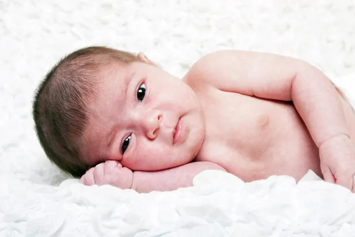 Framed Print : Cute baby face Cute Caucasian Hispanic infant baby with big eyes laying on side on soft white cotton cloud with hand Framed Print : Cute baby face Cute Caucasian Hispanic infant baby with big eyes laying on side on soft white cotton cloud with hand