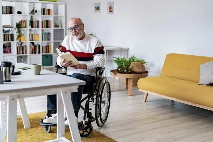 Framed Print : Serious disabled man holding diary at home office