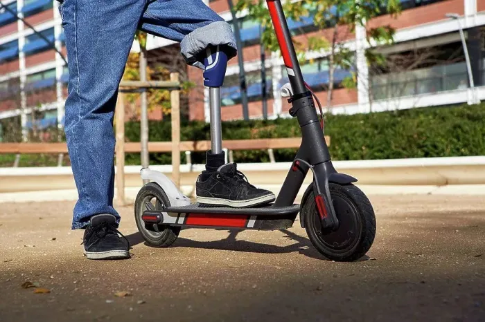 Framed Print : Disabled man with prosthetic leg standing on electric push scooter in playground Framed Print : Disabled man with prosthetic leg standing on electric push scooter in playground