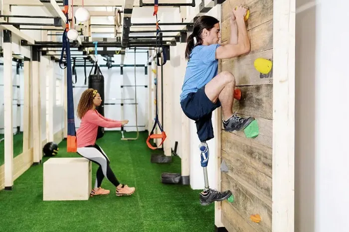 Framed Print : Disabled sportsman climbing wall in gym Framed Print : Disabled sportsman climbing wall in gym