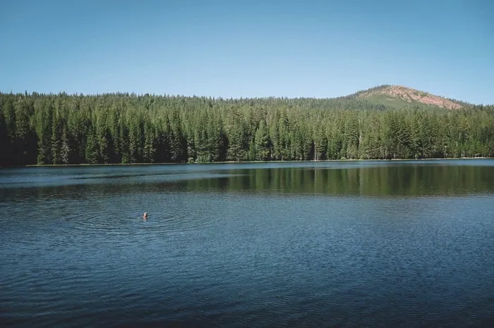 Framed Print : Distant View of Boy Treading Water in the Center of a Scenic Lake Framed Print : Distant View of Boy Treading Water in the Center of a Scenic Lake