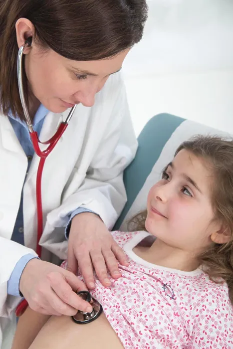 Framed Print : Doctor auscultating a girl