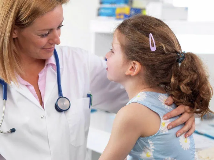 Framed Print : Doctor comforting a 5 year old girl in a clinic Framed Print : Doctor comforting a 5 year old girl in a clinic