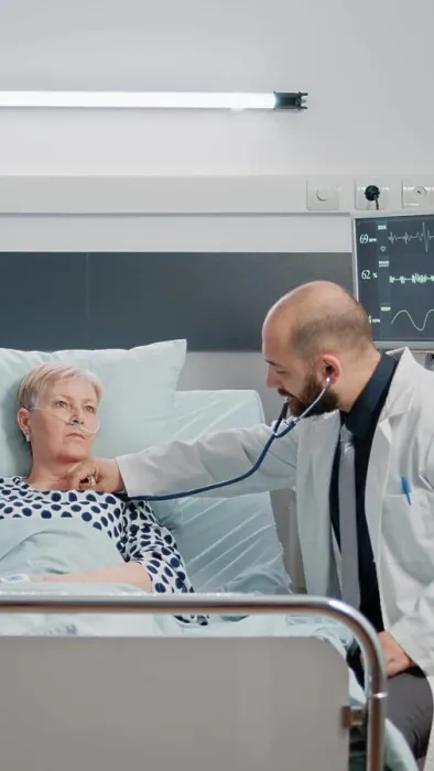 Framed Print : Doctor consulting sick patient with stethoscope in hospital ward