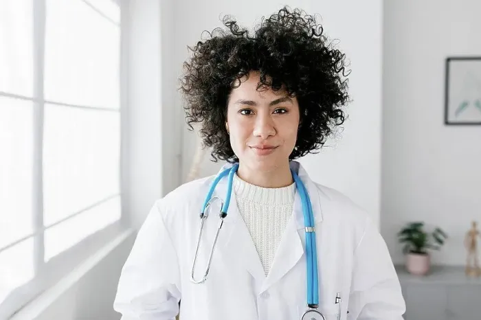 Framed Print : Doctor with curly hair at medical clinic Framed Print : Doctor with curly hair at medical clinic
