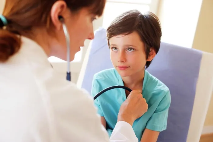 Framed Print : Doctor examining a 9 years old boy with a stethoscope Framed Print : Doctor examining a 9 years old boy with a stethoscope