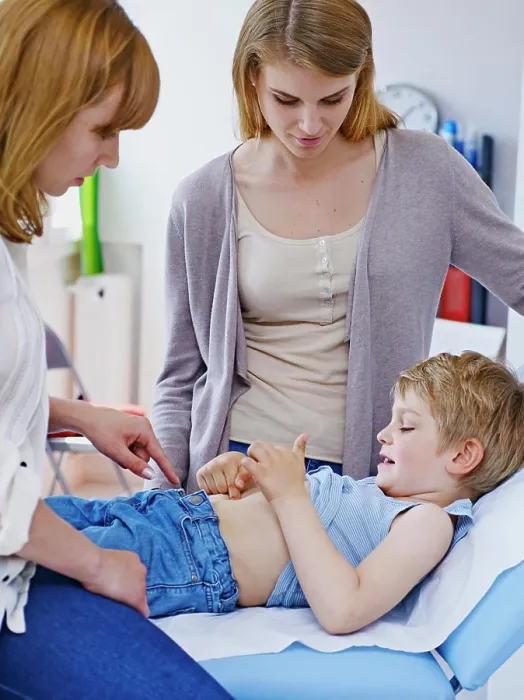 Framed Print : Doctor examining a child's abdomen Framed Print : Doctor examining a child's abdomen