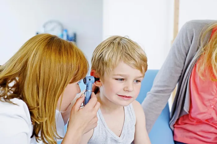Framed Print : Doctor examining a child's ear Framed Print : Doctor examining a child's ear