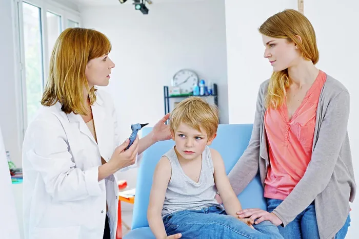 Framed Print : Doctor examining a child's ear