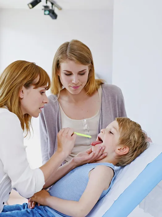 Framed Print : Doctor examining a child's throat Framed Print : Doctor examining a child's throat