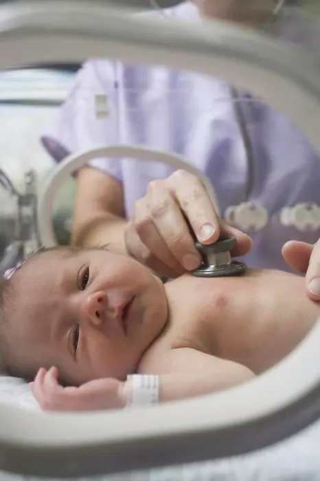 Framed Print : Doctor examining a newborn baby boy Framed Print : Doctor examining a newborn baby boy
