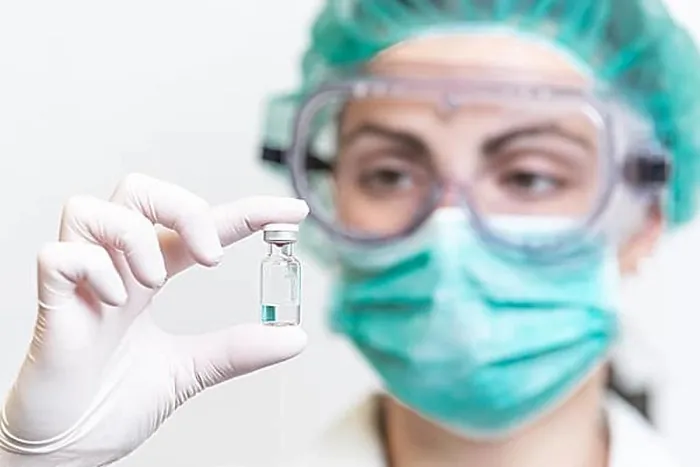 Framed Print : Doctor or nurse in protective gloves holding vaccine vial for Coronavirus outbreak pandemic. Medicine and drug concept