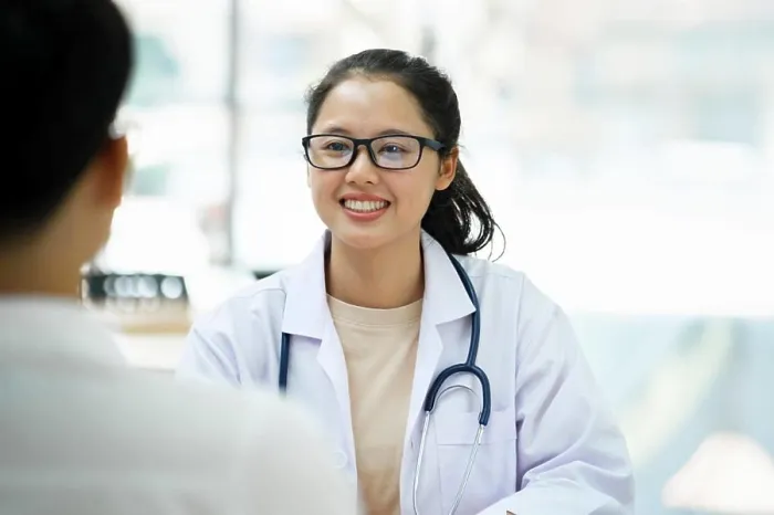 Framed Print : Doctor talking to a patient at medical clinic Framed Print : Doctor talking to a patient at medical clinic