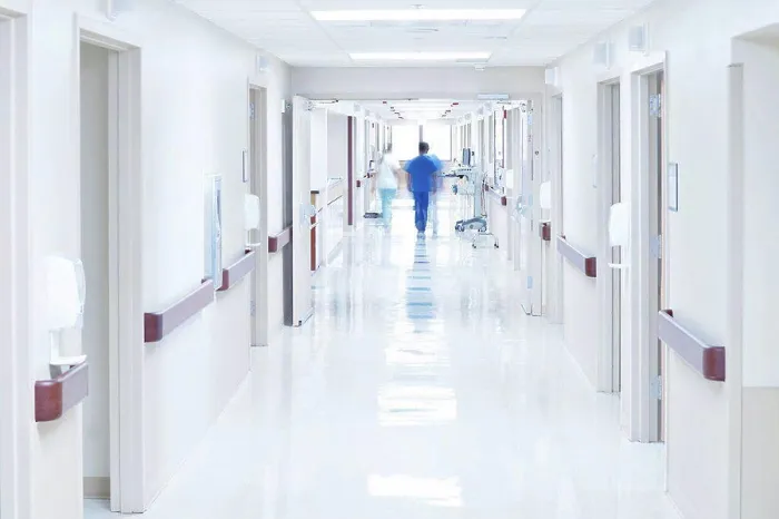 Framed Print : Doctor walking down hospital corridor Framed Print : Doctor walking down hospital corridor