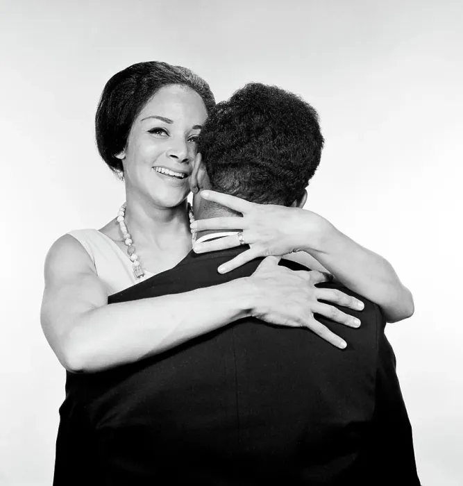 Framed Print : Embracing African-american married couple, studio shot