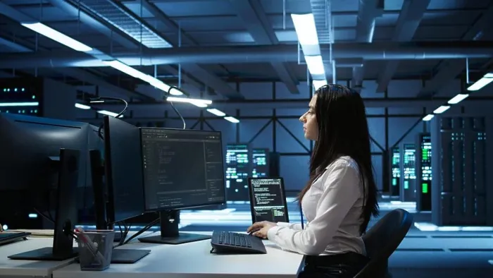 Framed Print : Engineer in data center sitting down at desk Framed Print : Engineer in data center sitting down at desk