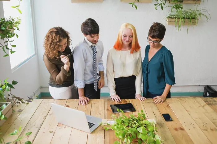 Framed Print : Four entrepreneurs looking at a tablet Framed Print : Four entrepreneurs looking at a tablet