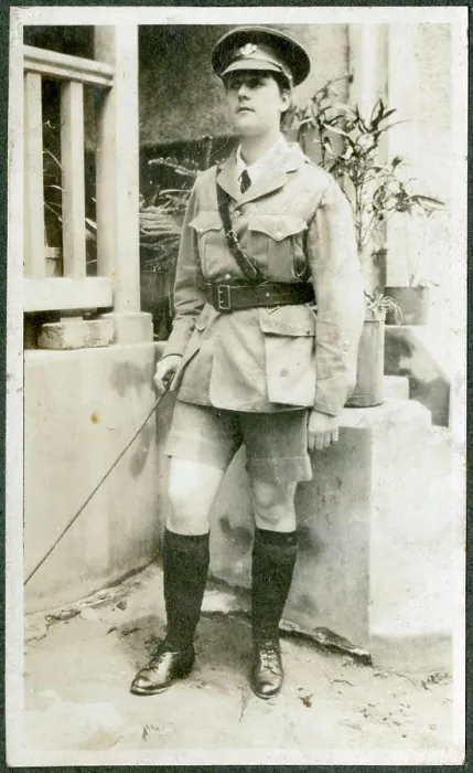 Framed Print : A European woman poses outside a brick-built house dressed up in army uniform and carrying a cane Framed Print : A European woman poses outside a brick-built house dressed up in army uniform and carrying a cane