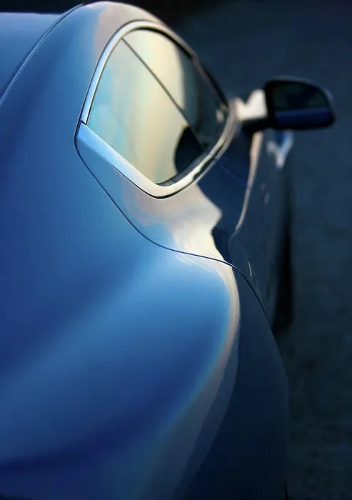Framed Print : Exterior detail view of a blue 2012 Aston Martin Rapide showing the right doors and rear view mirror Framed Print : Exterior detail view of a blue 2012 Aston Martin Rapide showing the right doors and rear view mirror