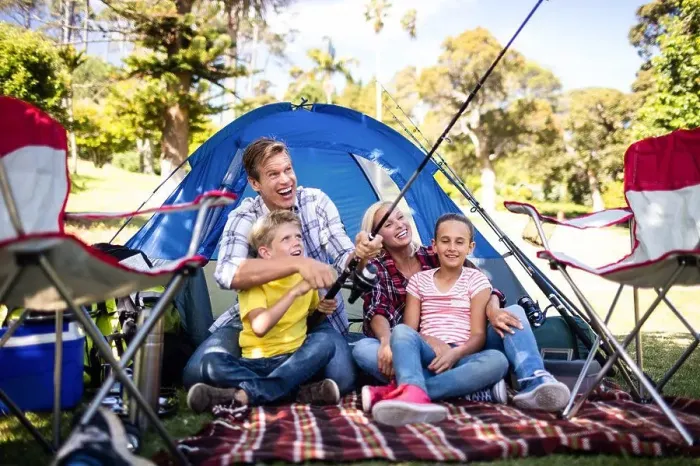 Framed Print : Family on a camping trip fishing outside their tent Framed Print : Family on a camping trip fishing outside their tent