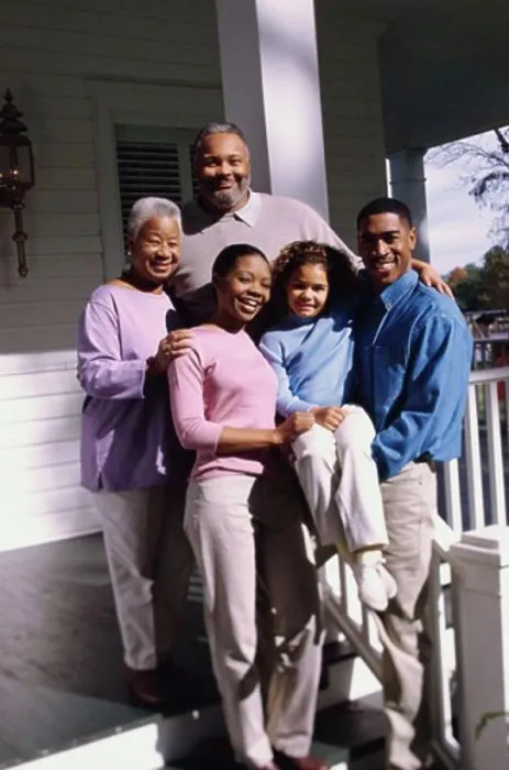 Framed Print : Family standing in front of a house Framed Print : Family standing in front of a house