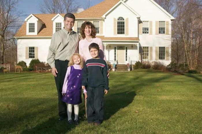 Framed Print : Family standing outside their house Framed Print : Family standing outside their house