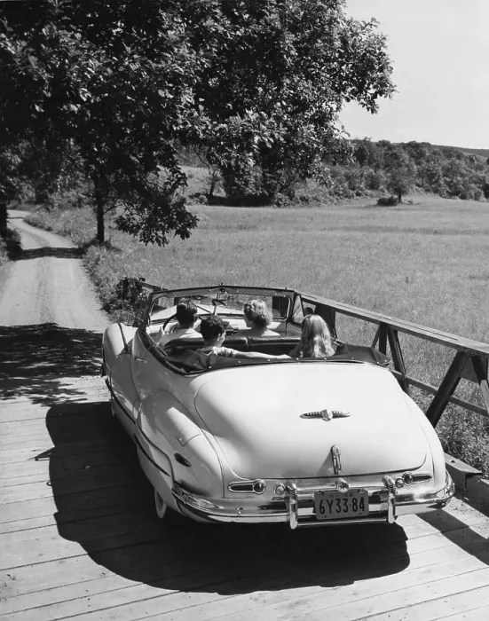 Framed Print : Family traveling in convertible car