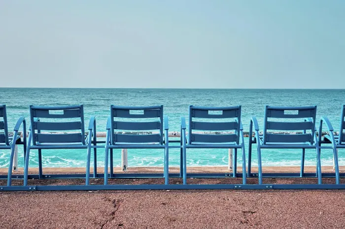 Framed Print : Famous blue chairs bench on beach in the morning. Nice, France Framed Print : Famous blue chairs bench on beach in the morning. Nice, France
