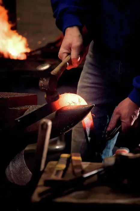 Framed Print : Farrier forging horseshoe on anvil
