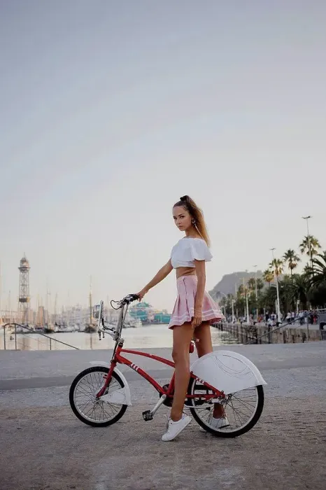 Framed Print : Fashionable young woman exploring Barcelona with a bicycle Framed Print : Fashionable young woman exploring Barcelona with a bicycle