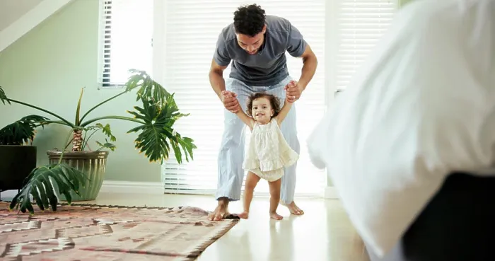 Framed Print : Father, child and learning to walk in home with holding hands
