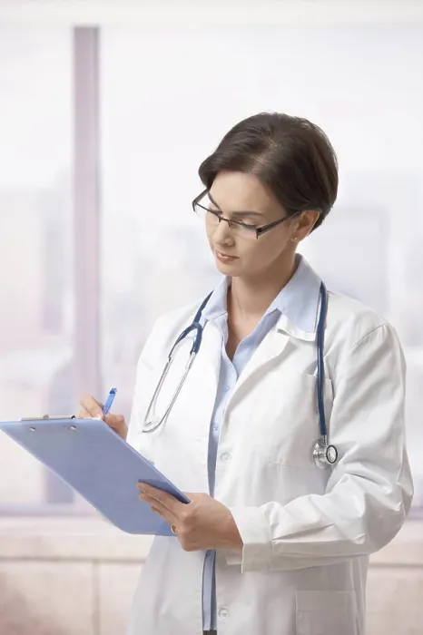 Framed Print : Female doctor doing paperwork in hospital Attractive female doctor standing on hospital corridor doing paperwork Framed Print : Female doctor doing paperwork in hospital Attractive female doctor standing on hospital corridor doing paperwork