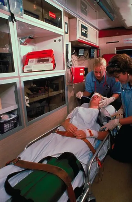 Framed Print : Two female emergency medical technicians attend to a patient in the back of an ambulance Framed Print : Two female emergency medical technicians attend to a patient in the back of an ambulance