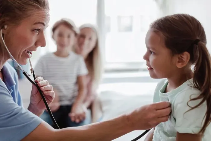 Framed Print : Female pediatrician listening to girl's heartbeat through stethoscope at clinic Framed Print : Female pediatrician listening to girl's heartbeat through stethoscope at clinic