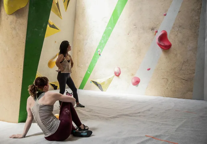 Framed Print : Female rock climbers resting at climbing wall Framed Print : Female rock climbers resting at climbing wall