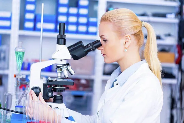 Framed Print : Female scientist using microscope in the laboratory Framed Print : Female scientist using microscope in the laboratory
