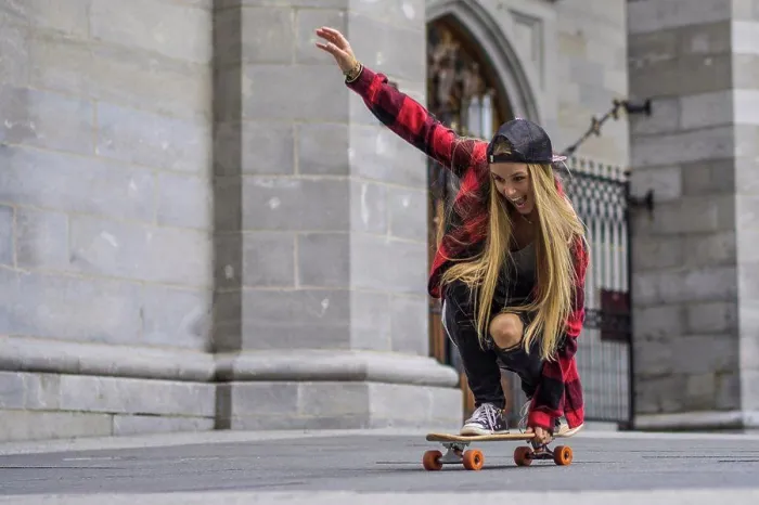 Framed Print : Female skateboarder balancing herself on skateboard rolling arou Framed Print : Female skateboarder balancing herself on skateboard rolling arou