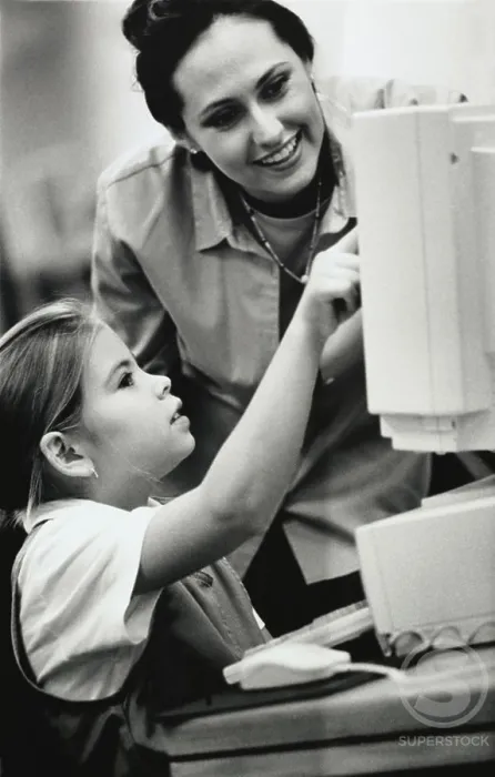 Framed Print : Female teacher and her student in front of a computer Framed Print : Female teacher and her student in front of a computer