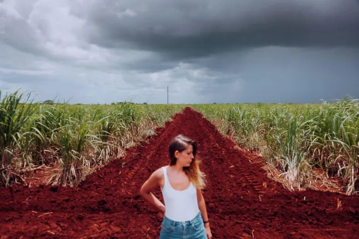Framed Print : Female traveler in casual wear standing on crossroad with brown soil among green tropical plants under grey cloudy Framed Print : Female traveler in casual wear standing on crossroad with brown soil among green tropical plants under grey cloudy