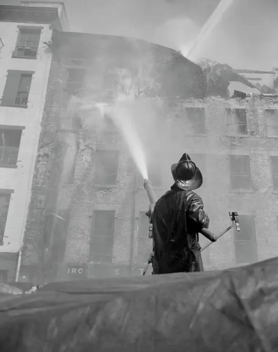 Framed Print : Firefighter pouring water on burning building, low angle view Framed Print : Firefighter pouring water on burning building, low angle view