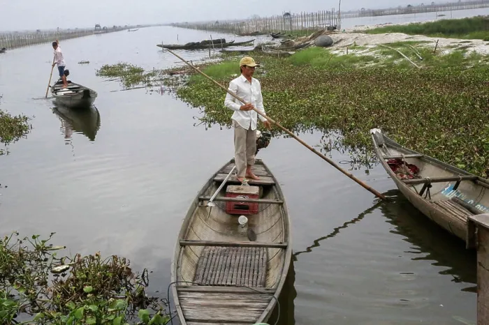 Framed Print : A fisherman from a small fishing village sets out sets out in his canoe in Hue Province Framed Print : A fisherman from a small fishing village sets out sets out in his canoe in Hue Province