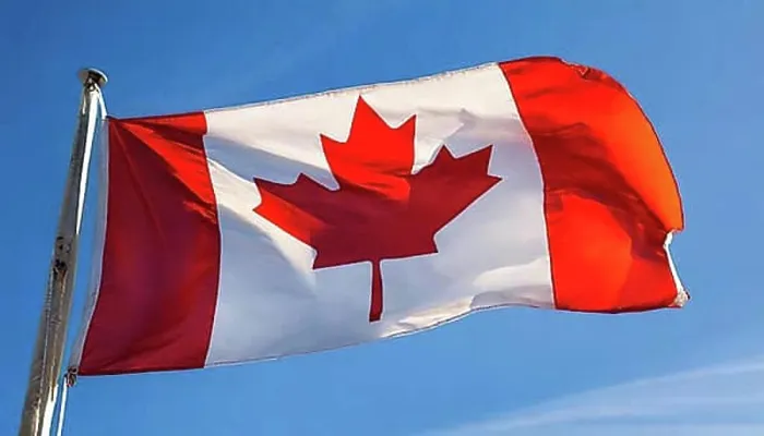 Framed Print : The flag of Canada flutters in the wind, isolated against a blue sky Framed Print : The flag of Canada flutters in the wind, isolated against a blue sky