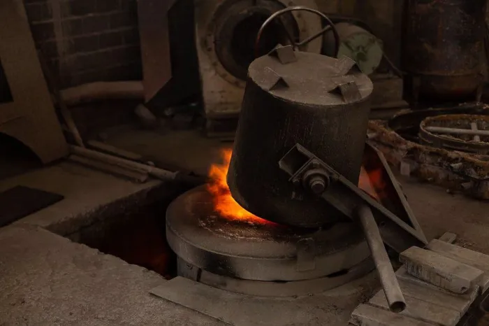 Framed Print : flask heating on furnace in foundry