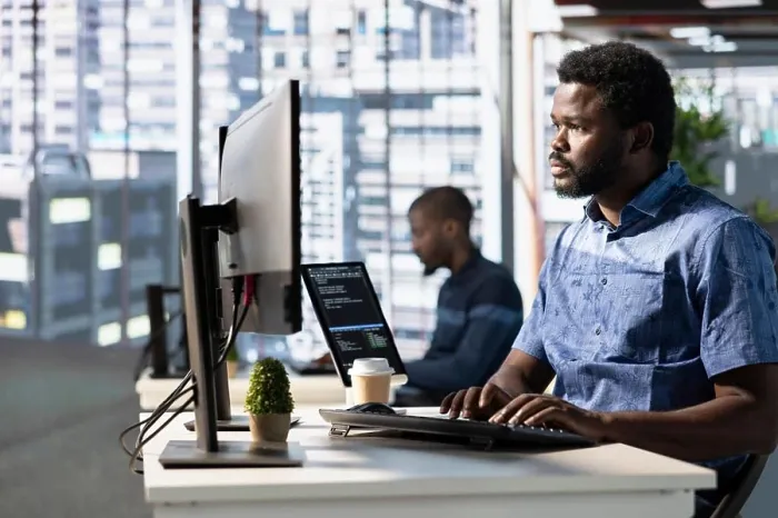 Framed Print : Focused employee analyzing datasets Framed Print : Focused employee analyzing datasets