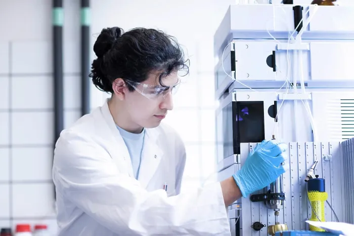 Framed Print : A focused scientist operating laboratory equipment Framed Print : A focused scientist operating laboratory equipment